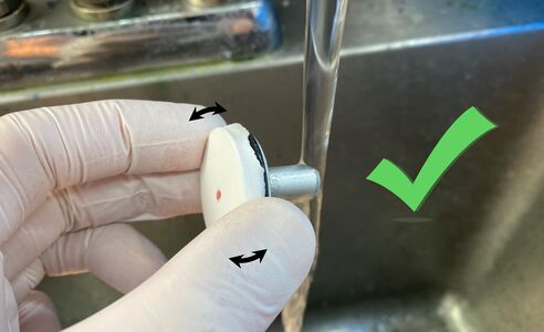 Rather, apply hot water to the stem of the chuck, while slightly tilting your grip of the top to apply pressure towards making the block slide off the chuck. As soon as you feel it starting to move, move away from the sink and finish sliding the block off the chuck.